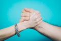 Shaking hands of two people, isolated on blue Royalty Free Stock Photo