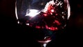 Shaking red wine glass by man hand. Stock footage. Close up of a sommelier is shaking wineglass with red wine in his Royalty Free Stock Photo