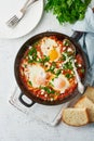Shakshouka, eggs poached in sauce of tomatoes, olive oil. Mediterranean cuisine. Royalty Free Stock Photo