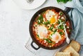 Shakshouka, eggs poached in sauce of tomatoes, olive oil. Mediterranean cuisine.