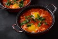 Shakshouka, eggs poached in sauce of tomatoes, olive oil, peppers, onion and garlic Royalty Free Stock Photo