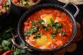 Shakshouka, eggs poached in sauce of tomatoes, olive oil, peppers, onion and garlic Royalty Free Stock Photo