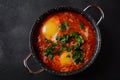 Shakshouka, eggs poached in sauce of tomatoes, olive oil, peppers, onion and garlic Royalty Free Stock Photo