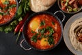 Shakshouka, eggs poached in sauce of tomatoes, olive oil, peppers, onion and garlic Royalty Free Stock Photo