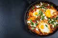 Shakshouka - Middle eastern traditional dish with poached eggs in tomato sauce