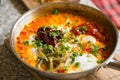 Shakshouka with peppers & tomato paste, eggs, ras-el-hanout, chipotle peppers and pickled nopales