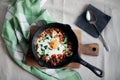 Shakshouka with poached egg in rich tomato sauce and spices