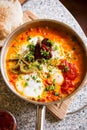 Shakshouka with peppers & tomato paste, eggs, ras-el-hanout, chipotle peppers and pickled nopales