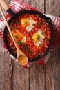 Shakshuka breakfast of fried eggs and tomatoes in a pan. vertical top view Royalty Free Stock Photo