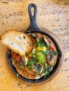 Shakshuka of fried eggs in a pan. vertical view from above Royalty Free Stock Photo