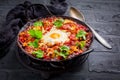 Shakshuka - dish of eggs poached in a tomato sauce with Feta cheese and coriander