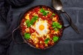 Shakshuka - dish of eggs poached in a tomato sauce with Feta cheese and coriander
