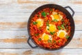 Shakshuka - fried eggs, onion, bell pepper, tomatoes and spices Royalty Free Stock Photo