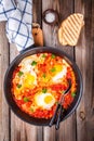 Shakshuka. Fried eggs with tomato, paprika and parsley