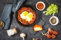 Shakshuka, Fried Eggs in Tomato Sauce in iron frying pan. Typical Israel food