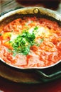 Shakshuka. Traditional jewish food and middle eastern cuisine recipe. Fried eggs, tomatoes, bell pepper and parsley in a