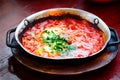 Shakshuka. Traditional jewish food and middle eastern cuisine recipe. Fried eggs, tomatoes, bell pepper and parsley in a