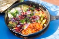 Shaksouka Hola Mexico. Eggs baked in aromatic tomato and peppers paste, with beans, served with marinated cactus, guacamole, salsa