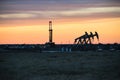 Shale Oil Rig and Pumpjack during sunset Royalty Free Stock Photo