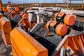 Shale shaker on an offshore oil rig. Shale shaker screen close up view with drill cutting flow out from oil base mud. Separators