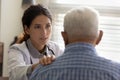 Trusted therapist support old man patient hold hand on shoulder