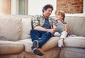 Shall we watch our favourite movie. a father and his little daughter using a digital tablet at home.