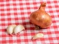 Shallot and garlic cloves on a kitchen table Royalty Free Stock Photo