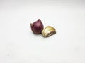 Shallot and single garlic clove resting on plain white background surface Royalty Free Stock Photo