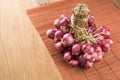 Shallots group on wood and bamboo background Royalty Free Stock Photo