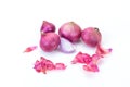 Shallots and pieces of peel are put on white table as background. It is a Thai onion, Thai herb