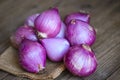 Shallots or red onion, purple shallots on wooden background , fresh shallot for medicinal products or herbs and spices Thai food