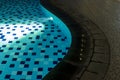 Shallow blue pool lighting in evening for design and backyard deck planning for family space.