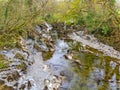 Shallow, clear water of the  River Mawddach flowing gently ithrough the Welsh countryside Royalty Free Stock Photo