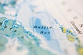 Shallow depth of field focus on geographical map location of Baffin Bay off coast of Greenland on atlas