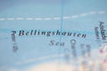 Shallow depth of field focus on geographical map location of Bellingshausen Sea off coast of Antarctica on atlas