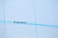 Shallow depth of field focus on geographical map location of Equator line on atlas