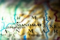 Shallow depth of field focus on geographical map location of Mandalay city in Bruma Myanmar Indochina Asia continent on atlas