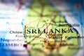 Shallow depth of field focus on geographical map location of Sri Lanka Asia continent on atlas