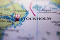 Shallow depth of field focus on geographical map location of Stockholm city Sweden Scandinavia Europe continent on atlas