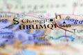 Shallow depth of field focus on geographical map location of Urumqi city China Asia continent on atlas