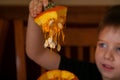 Little Boy Lifts Top Off of a Pumpkin He is Excited to Carve Royalty Free Stock Photo