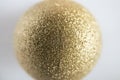 Shallow depth of field of gold glitter colored Christmas bauble. Royalty Free Stock Photo