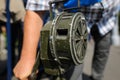 Shallow depth of field image with a man handling a vintage hand crank air raid siren