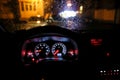 Shallow depth of field image selective focus with the steering wheel and dashboard lights of a 2010 car and the windscreen with Royalty Free Stock Photo