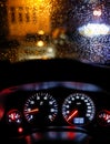 Shallow depth of field image selective focus with the steering wheel and dashboard lights of a 2010 car and the windscreen with