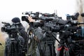 Shallow depth of field image with television video cameras and recording equipment during a press event