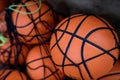 Shallow depth of field (selective focus) details with a cheap plastic basketball in a heap in a public school