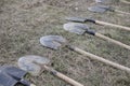 Shallow depth of field selective focus details of dirty shovels during a tree plantation