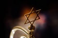 Shallow depth of field selective focus details with a metal star of David decoration inside a synagogue