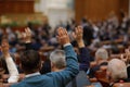 Shallow depth of field selective focus with details of Romanian MPs voting by raising their hands